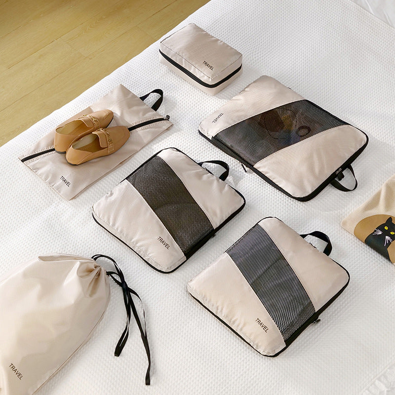 Six packing cubes plus shoe bag and toiletry pouch laid out